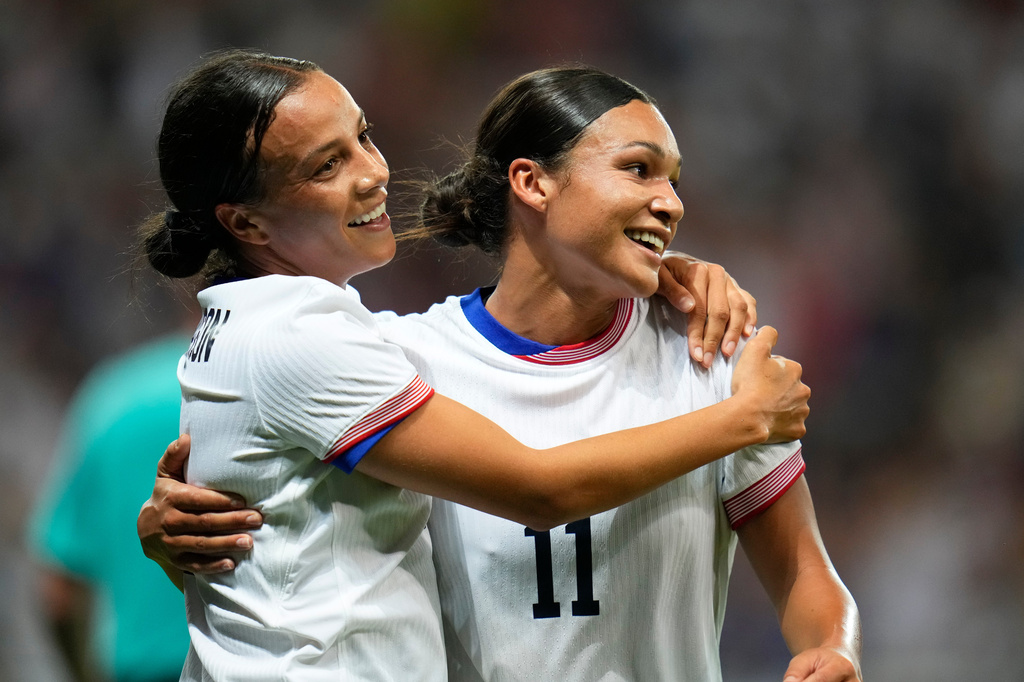 FILE - United States' Mallory Swanson, left, reacts with teammate Sophia Smith after scoring her side's third goal during a women's group B match between the United States and Zambia at Nice Stadium at the 2024 Summer Olympics, July 25, 2024, in Nice, France. (AP Photo/Julio Cortez, File)