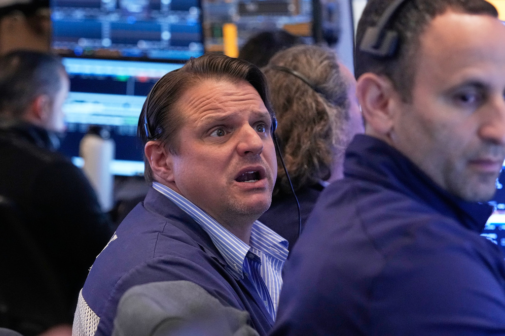 Trader Michael Milano, left, works on the floor of the New York Stock Exchange, Monday, April 20, 2026. (AP Photo/Richard Drew)
