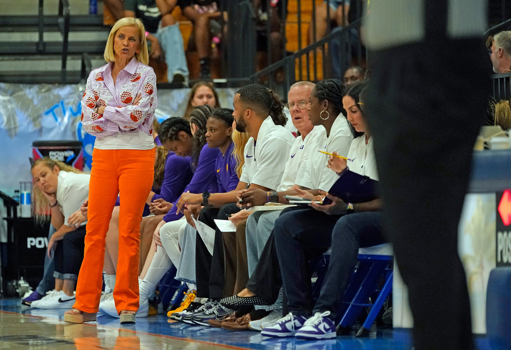 LSU head coach Kim Mulkey talks with one of her assistant coaches on the sidelines during the first quarter of their Reef Division championship game against Washington State at the Paradise Jam NCAA college basketball tournament in St. Thomas, U.S. Virgin Islands, Saturday, Nov. 29, 2025. (Bill Kiser/Virgin Islands Daily News via AP)