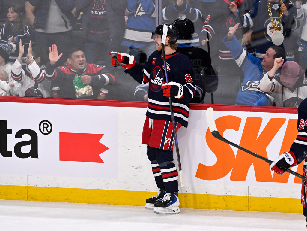 Winnipeg Jets' Kyle Connor, center, celebrates after his goal against the St. Louis Blues during third-period NHL hockey game action in Winnipeg, Manitoba, Sunday March 15, 2026. (Fred Greenslade/The Canadian Press via AP)