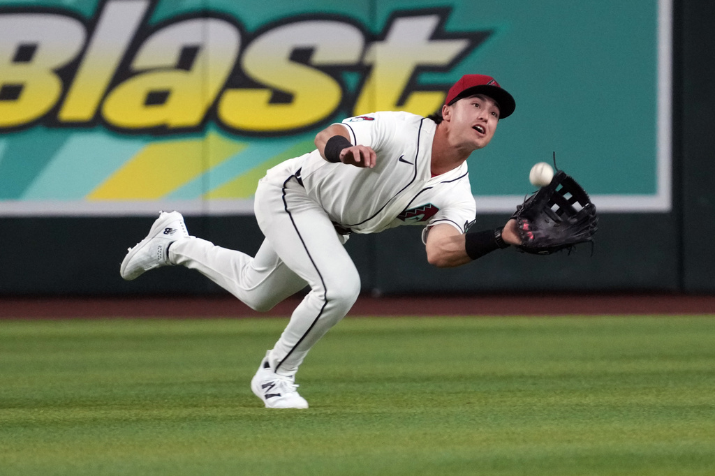 Arizona Diamondbacks outfielder Tommy Troy cannot catch a ball hit by Los Angeles Dodgers' Andy Pages in the third inning of a baseball game, Monday, June 1, 2026, in Phoenix. (AP Photo/Rick Scuteri)