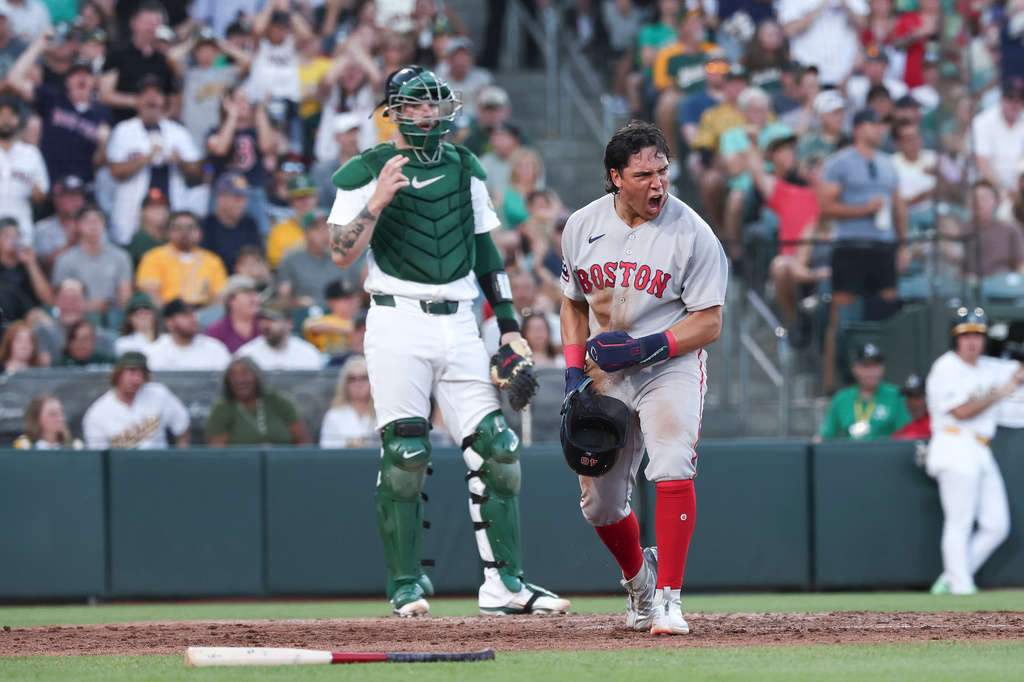 Boston Red Sox's Anthony Seigler, right, celebrates after scoring during the fifth inning of a baseball game against the Athletics Thursday, July 30, 2026, in West Sacramento, Calif. (AP Photo/Sara Nevis)