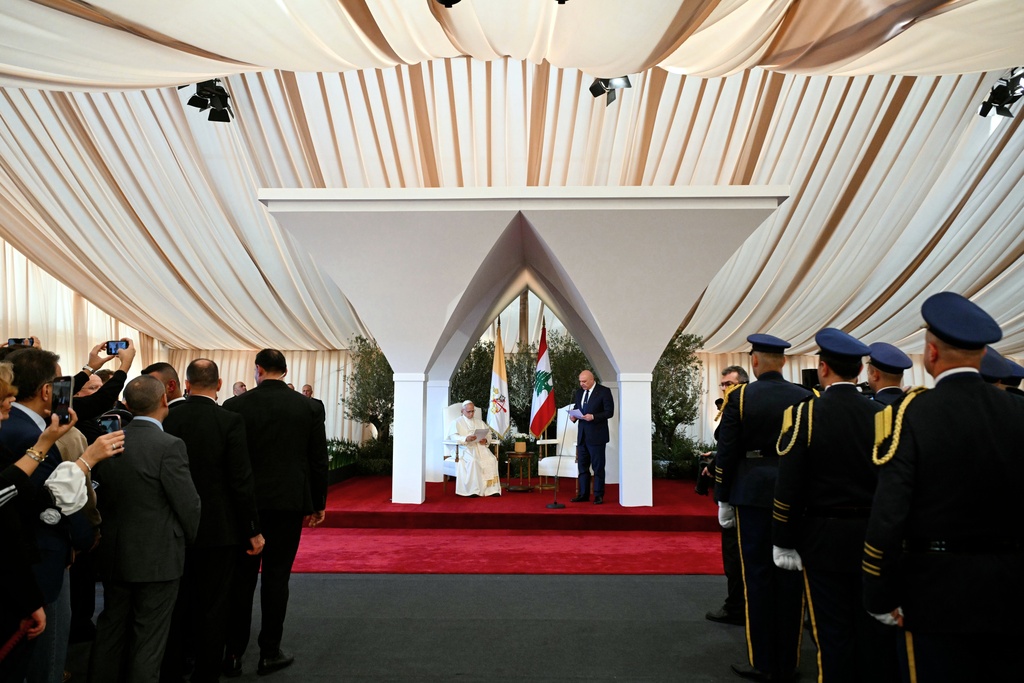 Pope Leo XIV delivers a speech next to Lebanese President Joseph Aoun during a farewell ceremony at the Beirut International Airport in Beirut, Lebanon, Tuesday, Dec. 2, 12025. (Andreas Solaro/Pool Photo via AP)