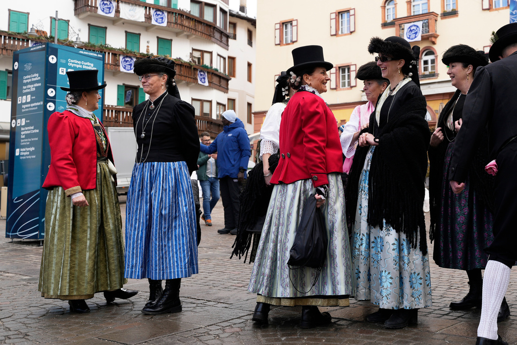 Women wear 18th century attire reserved for special occasions, in Cortina d'Ampezzo, Italy, one of the sites of the 2026 Winter Olympics, Wednesday, Feb. 11, 2026. (AP Photo/Robert F. Bukaty)