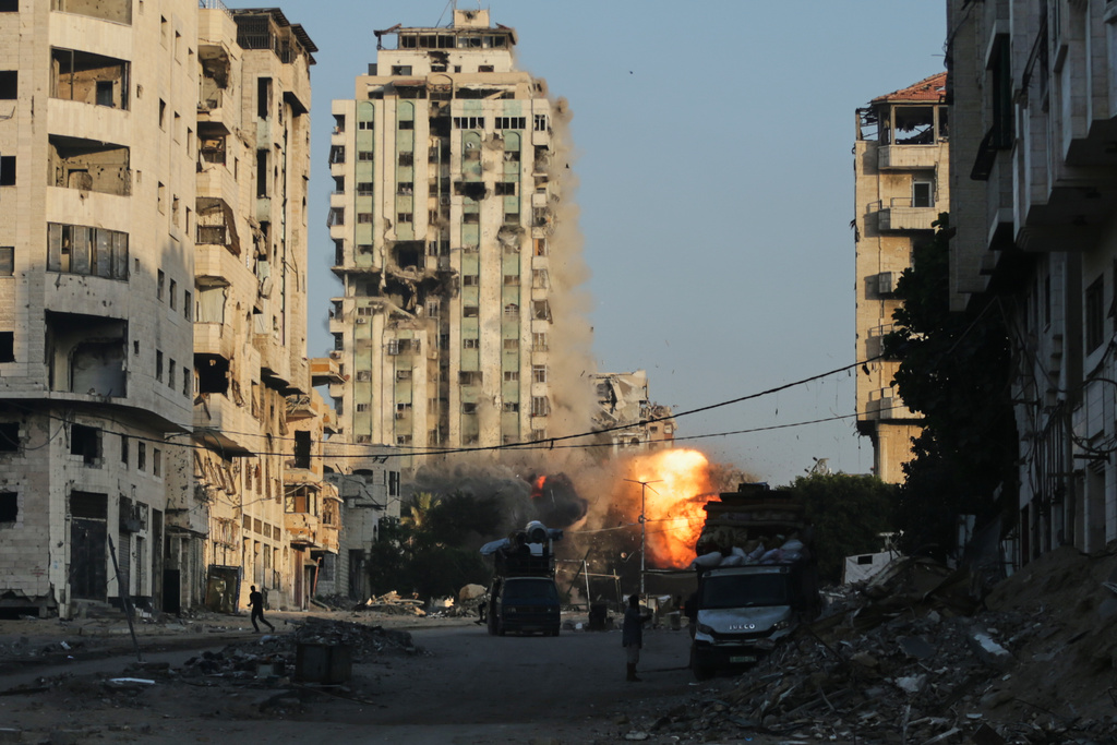 Smoke and fire rises from an Israeli airstrike on the Macca Tower, a high-rise building in Gaza City, Sunday, Sept. 28, 2025, following a prior warning issued by the Israeli army. (AP Photo/Yousef Al Zanoun)