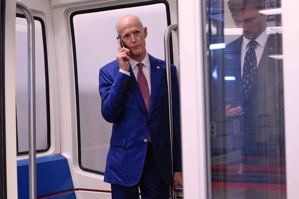 FILE - Sen. Rick Scott, R-Fla., talks on the phone at the Capitol subway in Washington, Sept. 17, 2025. (AP Photo/Mariam Zuhaib, File)