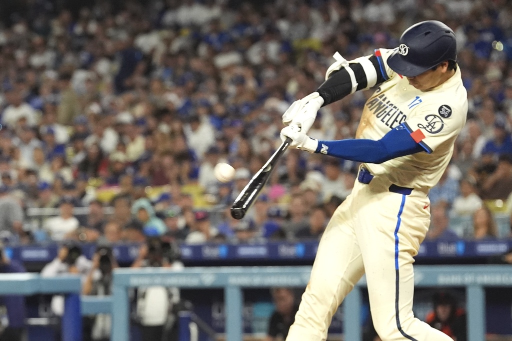 Los Angeles Dodgers' Shohei Ohtani hits a solo home run during the sixth inning of a baseball game against the San Francisco Giants, Saturday, Sept. 20, 2025, in Los Angeles. (AP Photo/Mark J. Terrill)