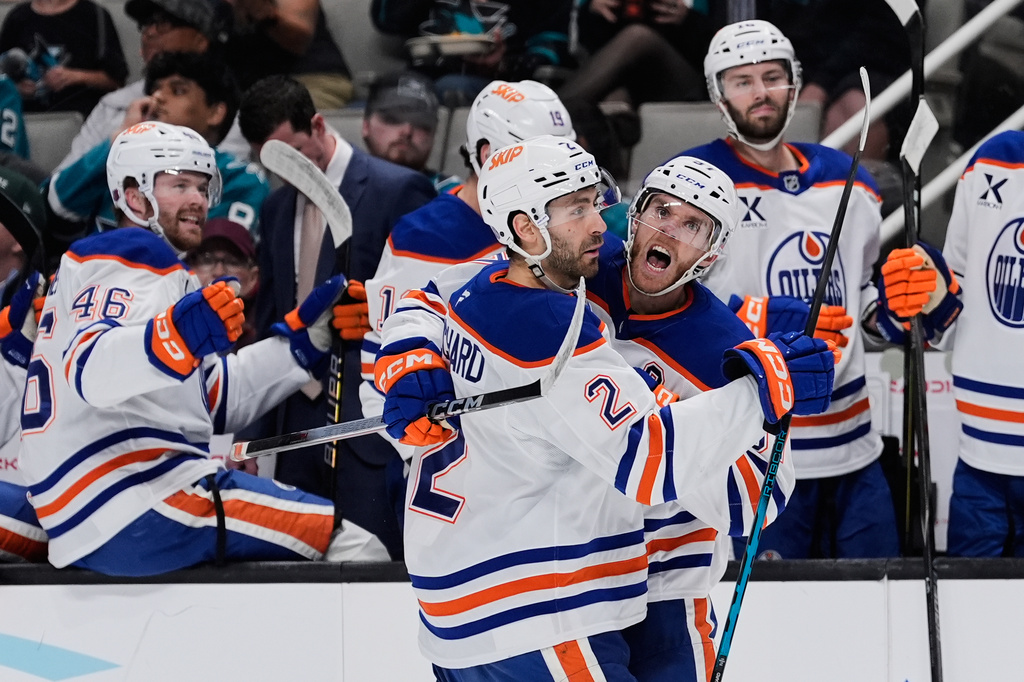 Edmonton Oilers center Connor McDavid, right, celebrates with defenseman Evan Bouchard (2) after scoring a goal during the second period of an NHL hockey game against the San Jose Sharks, Wednesday, April 8, 2026, in San Jose, Calif. (AP Photo/Godofredo A. Vásquez)