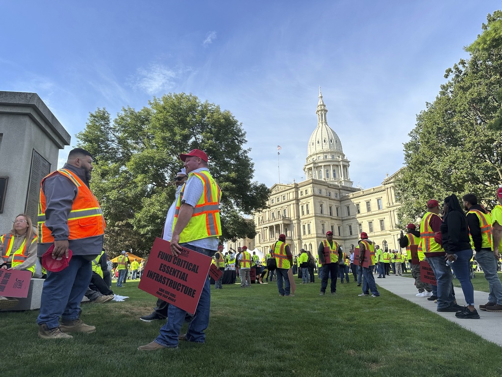 Construction workers gather at Michigan's statehouse in Lansing, Mich., Wednesday, Sept. 3, 2025, to call for a long-term road funding solution as a state government budget deadline approaches. (AP Photo/Isabella Volmert)