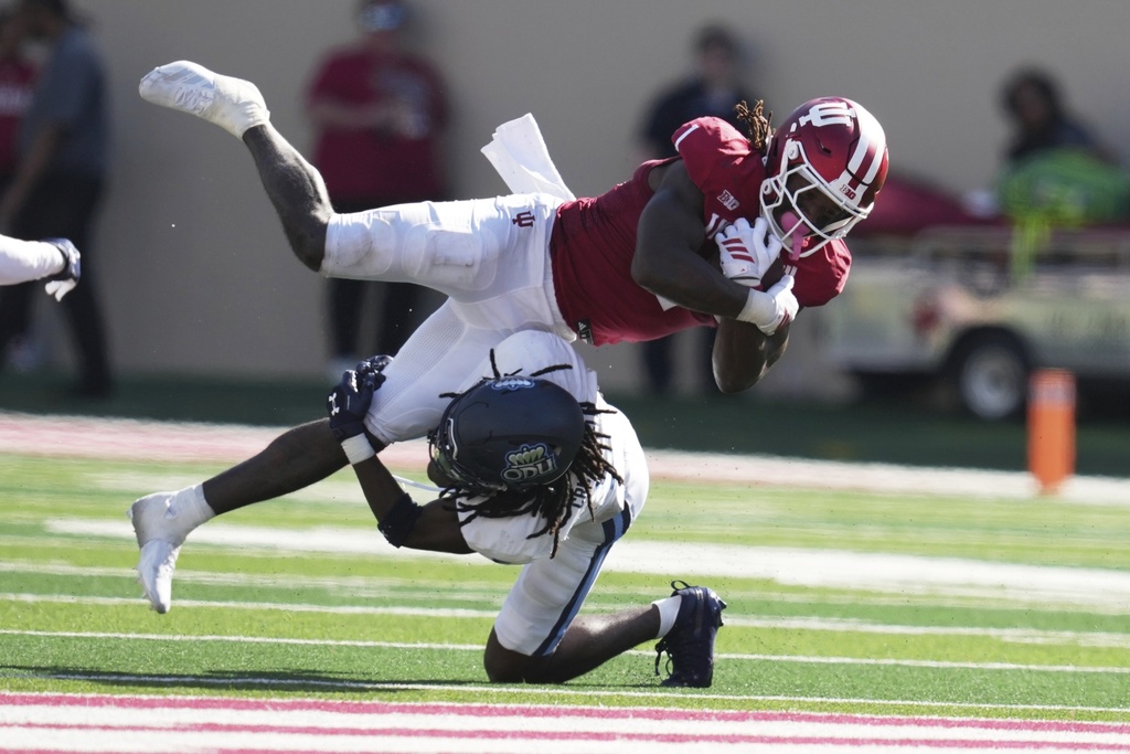 Indiana running back Roman Hemby (1) is tackled by Old Dominion cornerback Brandon Crutchfield (5) during the second half of an NCAA college football game, Saturday, Aug. 30, 2025, in Bloomington, Ind. (AP Photo/Darron Cummings)