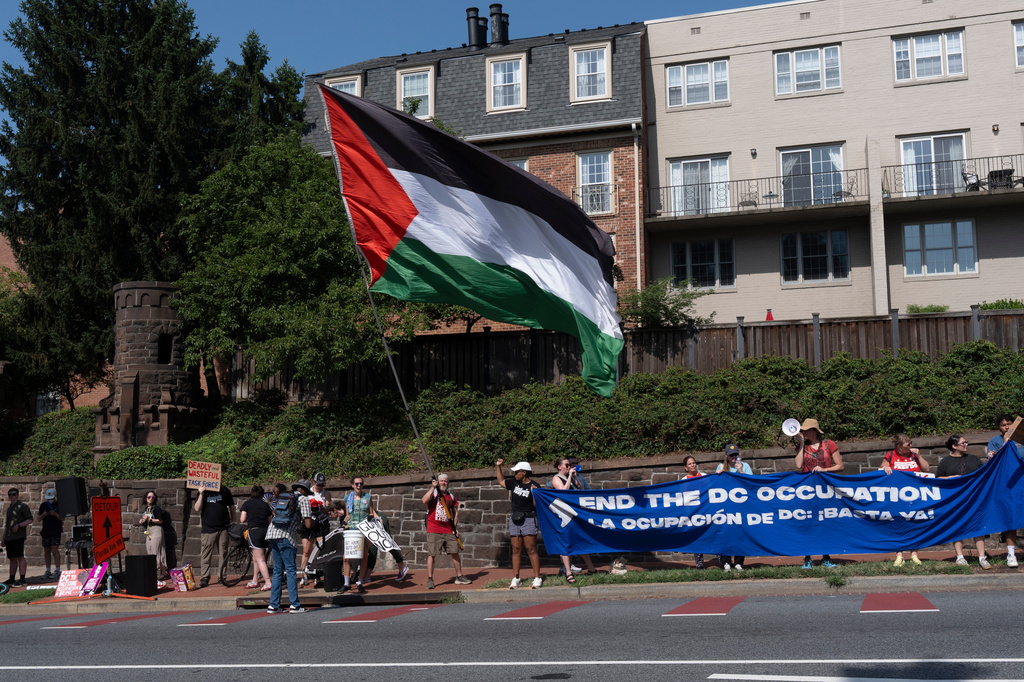 Protesters rally near a ceremony attended by Defense Secretary Pete Hegseth, Thursday, July 2, 2026, in Washington. (AP Photo/Manuel Balce Ceneta)