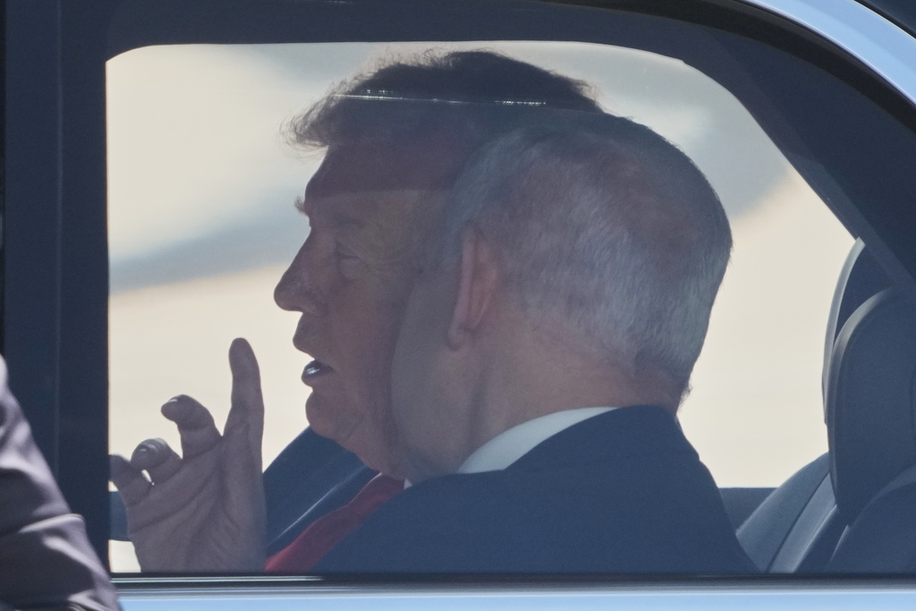 President Donald Trump speaks with Israeli Prime Minister Benjamin Netanyahu as they sit together in a car after a welcoming ceremony at Ben Gurion Airport near Tel Aviv, Israel, Monday, Oct. 13, 2025. (AP Photo/Ariel Schalit)
