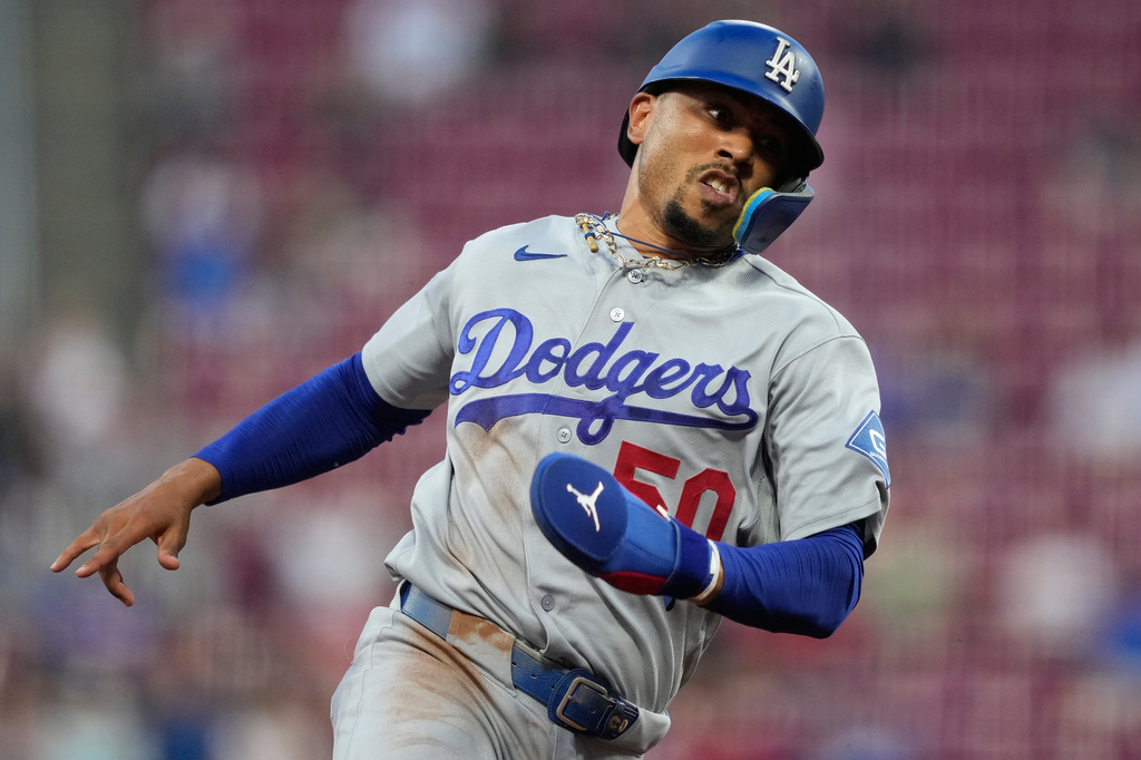 Los Angeles Dodgers' Mookie Betts rounds third base on his way to score on a double hit by Will Smith during the third inning of a baseball game against the Cincinnati Reds, Wednesday, Sept. 16, 2026, in Cincinnati. (AP Photo/Carolyn Kaster)
