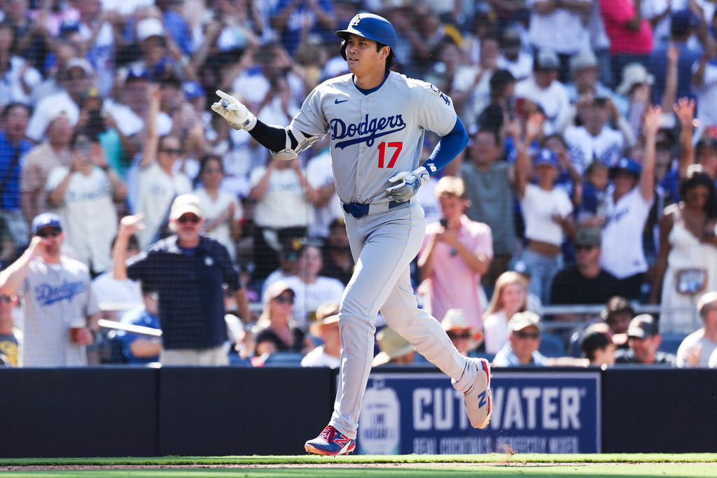 Los Angeles Dodgers' Shohei Ohtani gestures as he nears home after hitting a solo home run against the San Diego Padres in the ninth inning of a baseball game Sunday, Aug. 24, 2025, in San Diego. (AP Photo/Derrick Tuskan)