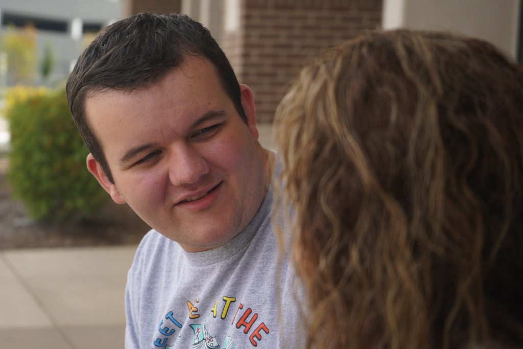 Rachel Deaton, director of training and legislation at the Autism Society of Indiana, sits with her 22-year-old autistic son, Luke, outside a public library in a northeastern suburb of Indianapolis, on Tuesday, Sept. 23, 2025. (AP Photo/Obed Lamy)