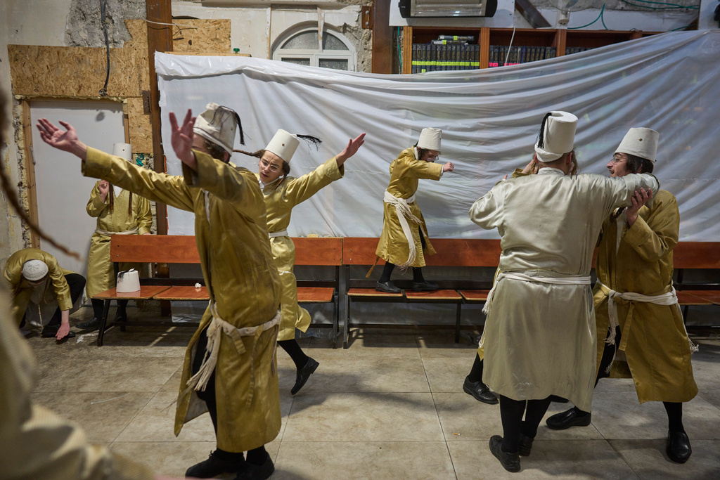 Ultra-Orthodox Jewish men celebrate the festival of Purim in Jerusalem, amid the war with Iran Wednesday, March 4, 2026. (AP Photo/Ohad Zwigenberg)