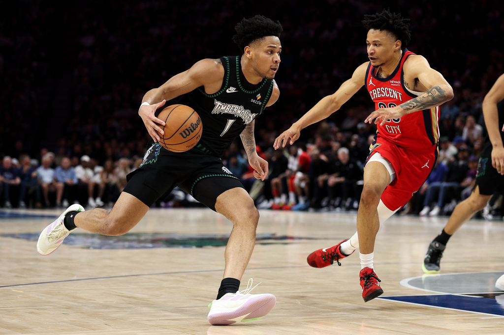 Minnesota Timberwolves guard Terrence Shannon Jr., left, drives toward the basket as New Orleans Pelicans guard Trey Alexander (23) defends during the first half of an NBA basketball game Sunday, April 12, 2026, in Minneapolis. (AP Photo/Matt Krohn)