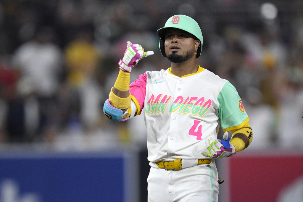 San Diego Padres' Luis Arraez celebrates after hitting a double during the eighth inning of a baseball game against the Los Angeles Dodgers, Friday, Aug. 22, 2025, in San Diego. (AP Photo/Orlando Ramirez)
