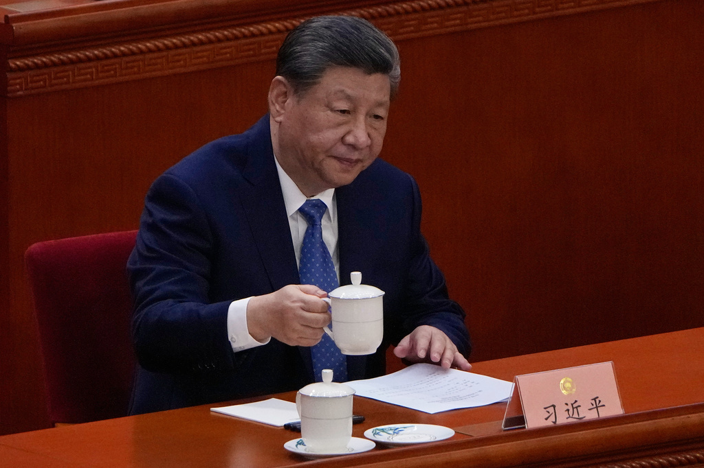 Chinese President Xi Jinping holds his cup of tea during the opening of the Chinese People's Political Consultative Conference at the Great Hall of the People, in Beijing, China, Wednesday, March 4, 2026. (AP Photo/Andy Wong)