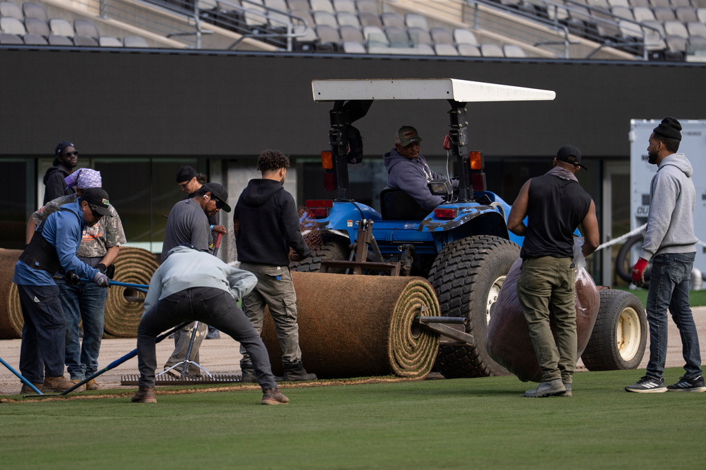 Workers install grass during the pitch installation for FIFA World Cup 2026 at NYNJ Stadium, Thursday, May 7, 2026, in East Rutherford, N.J. (AP Photo/Yuki Iwamura)