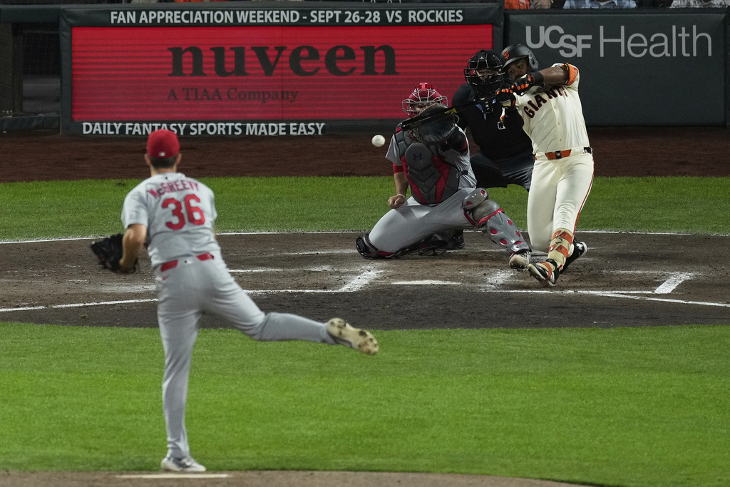 San Francisco Giants' Heliot Ramos, top right, hits a two-run single off of St. Louis Cardinals pitcher Michael McGreevy (36) during the fourth inning of a baseball game in San Francisco, Monday, Sept. 22, 2025. (AP Photo/Godofredo A. Vásquez)