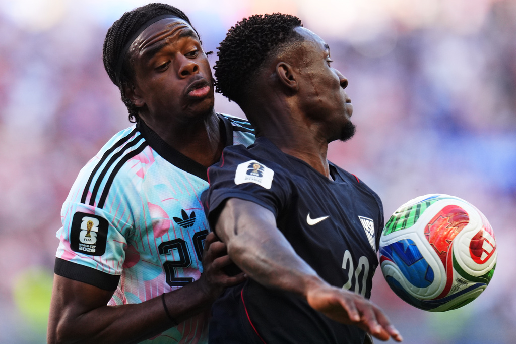 United States' Folarin Balogun, right, and Belgium's Nathan Ngoy battle for the ball during the World Cup round of 16 soccer match in Seattle, Monday, July 6, 2026. (AP Photo/Manu Fernandez)