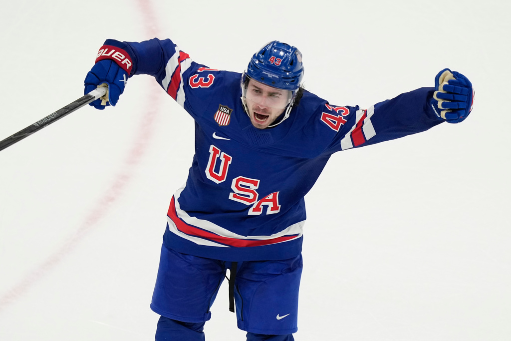 United States' Quinn Hughes celebrates after scoring the winning goal against Sweden during the overtime period of a men's ice hockey quarterfinal game at the 2026 Winter Olympics, in Milan, Italy, Wednesday, Feb. 18, 2026. (AP Photo/Hassan Ammar)