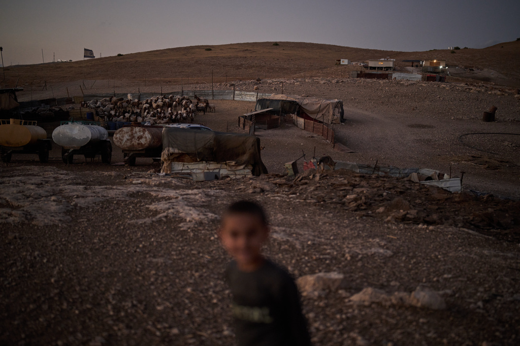 An Israeli settler outpost, top right, overlooks a Palestinian compound at dusk in the northern Jordan Valley in the occupied West Bank, Tuesday, June 23, 2026. (AP Photo/Leo Correa)