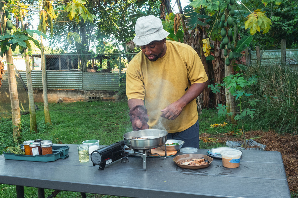 Rashad Frazier prepares food outdoors in Lava Lands, Ore., on Aug. 7, 2024. (Alex Forestier via AP)