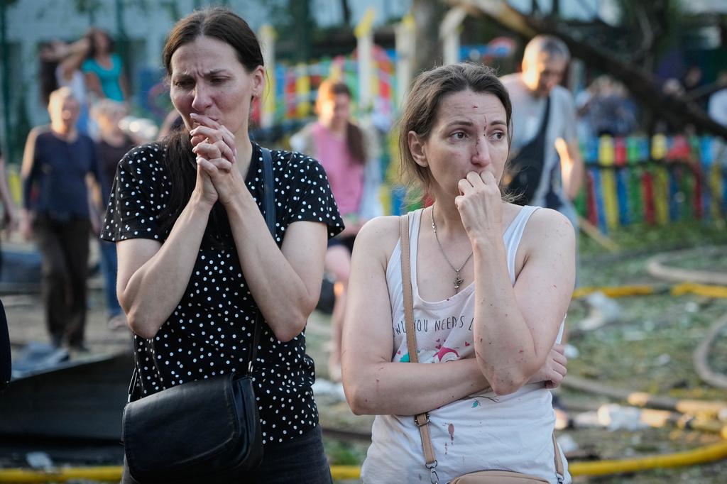 People react at the site of a Russian missile strike that hit a residential building in Kyiv, Ukraine, Thursday, July 2, 2026. (AP Photo/Efrem Lukatsky)