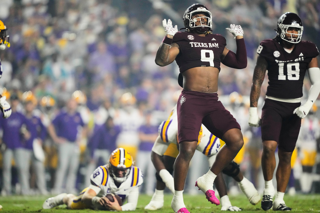 Texas A&M defensive end Cashius Howell (9) celebrates his sack of LSU quarterback Garrett Nussmeier (18) in the first half of an NCAA college football game, Saturday, Oct. 25, 2025 in Baton Rouge, La. (AP Photo/Gerald Herbert)