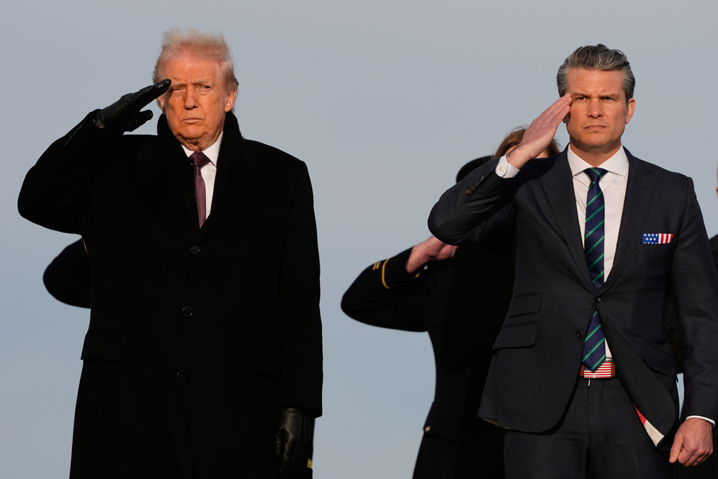 President Donald Trump and Defense Secretary Pete Hegseth salute as carry teams move the transfer cases with the remains of Iowa National Guard soldiers Sgt. William Nathaniel Howard, 29, of Marshalltown, Iowa, and Sgt. Edgar Brian Torres-Tovar, 25, of Des Moines, Iowa, and civilian interpreter Ayad Mansoor Sakat, who were killed in an attack in Syria, during a casualty return, Wednesday, Dec. 17, 2025 at Dover Air Force Base, Del. (AP Photo/Julia Demaree Nikhinson)