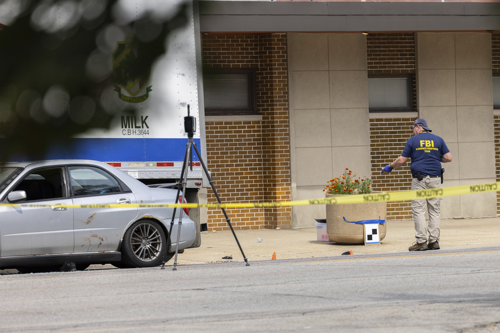 Law enforcement personnel investigate after the Department of Homeland Security said an Immigration and Customs Enforcement agent fatally shot a man in the Franklin Park suburb of Chicago on Friday, Sept. 12, 2025. (Candace Dane Chambers/Chicago Sun-Times via AP)