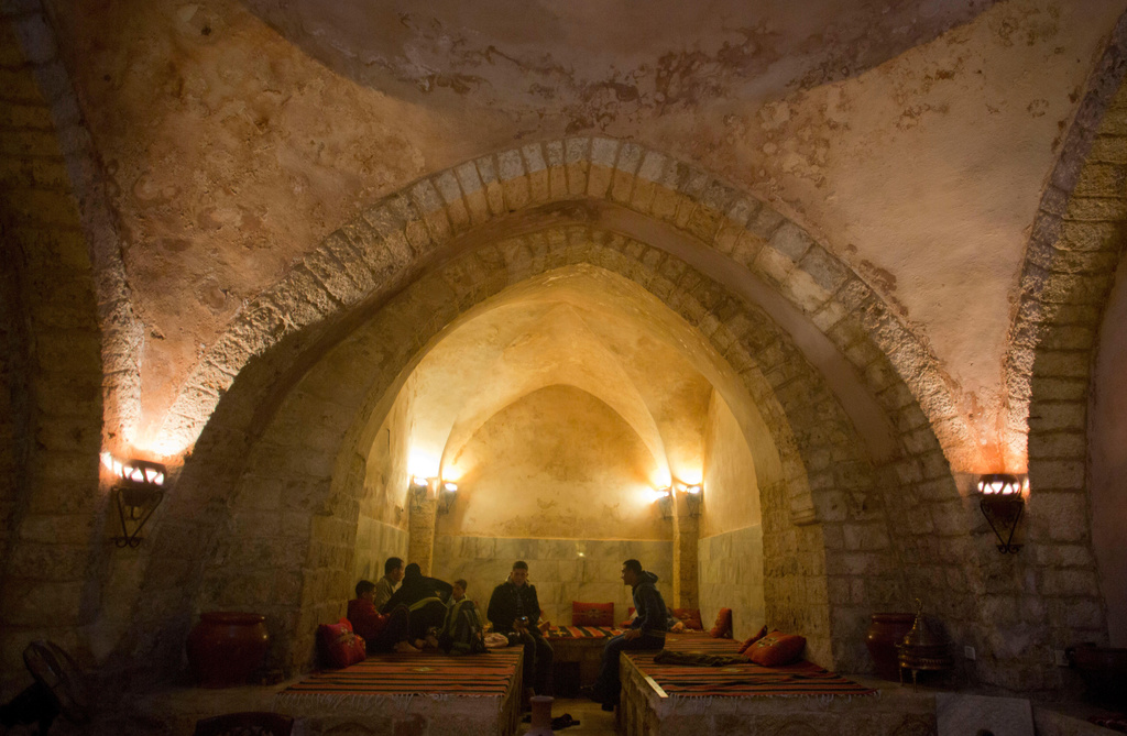 FILE - Palestinians rest at the reception of Hamam al-Sumara a historic bathhouse in Gaza City, Saturday, May 2, 2015. Hamam al-Sumara means "Samaritans' Bath" in Arabic. (AP Photo/Khalil Hamra, File)