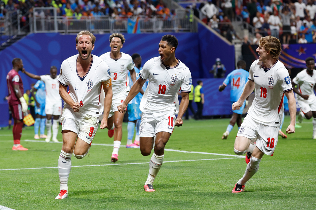England's Harry Kane (9) celebrates after scoring his side's first goal next to his teammate Jude Bellingham (10) and Anthony Gordon (18) during the World Cup round of 32 soccer match between England and Congo in Atlanta, Wednesday, July 1, 2026. (AP Photo/Butch Dill)