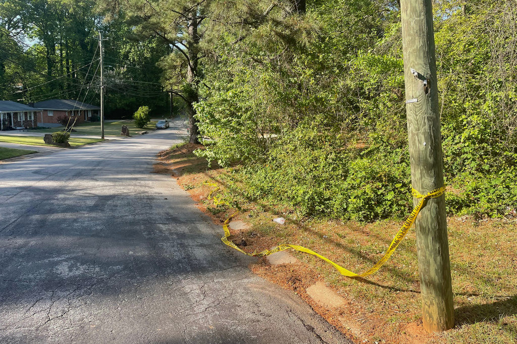 Crime scene tape is tied around a pole near the site where Lauren Bullis was killed, in Panthersville, Ga., Wednesday, April 15, 2026. (AP Photo/R.J. Rico)
