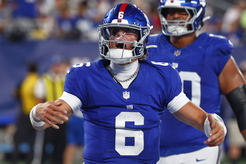 New York Giants quarterback Jaxson Dart (6) reacts after scoring a touchdown against the New York Jets during the third quarter of an NFL football game, Saturday, Aug. 16, 2025, in East Rutherford, N.J. (AP Photo/Noah K. Murray)