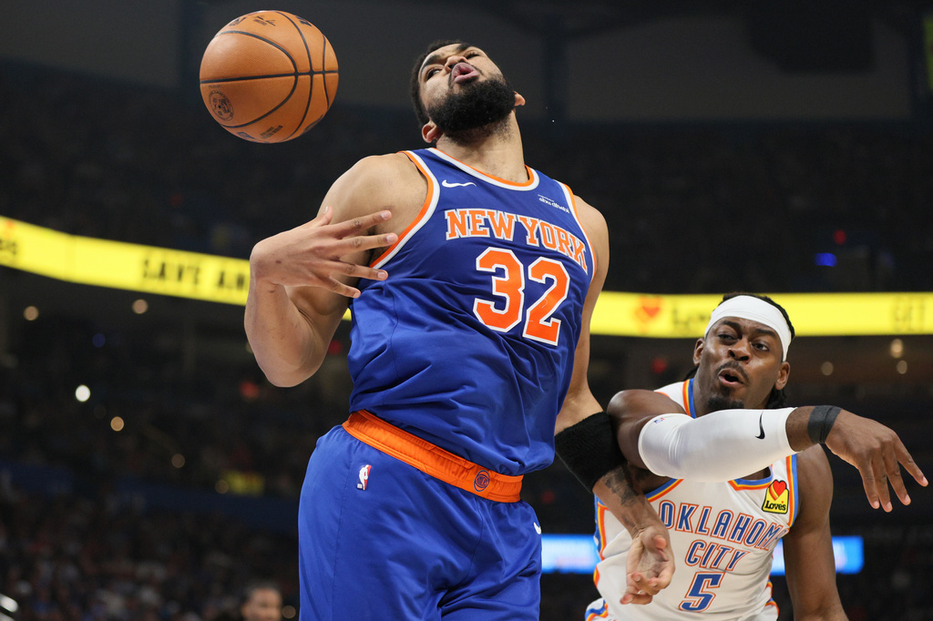 New York Knicks center Karl-Anthony Towns (32) loses control of the ball against Oklahoma City Thunder guard Luguentz Dort (5) during the first half of an NBA basketball game Sunday, March 29, 2026, in Oklahoma City. (AP Photo/Nate Billings)