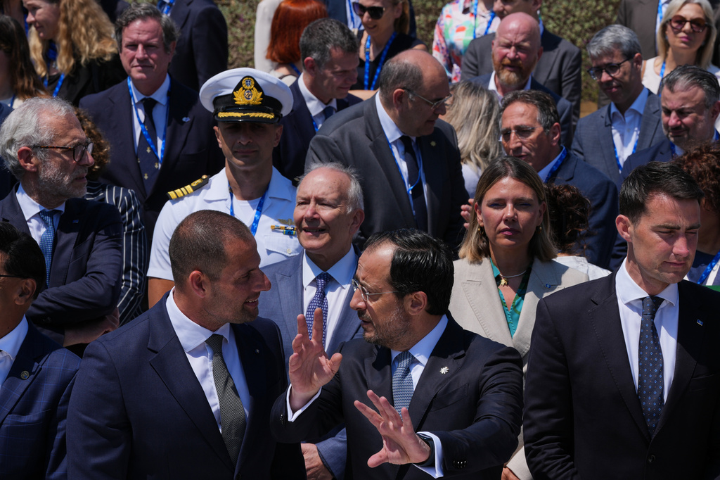 Cyprus' President Nikos Christodoulides, center, Malta's Prime Minister Robert Abela, center left, talks as they prepare for a family photo during the high-level conference "Strengthening Islands and Coastal Communities of the European Union" in the southwestern coastal city of Paphos on the eastern Mediterranean island of Cyprus, Friday, June 26, 2026. (AP Photo/Petros Karadjias)
