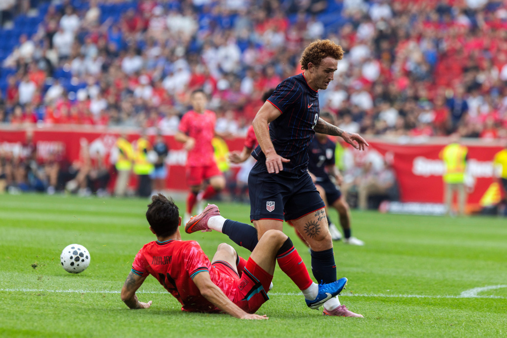 United States' Josh Sargent, right, battles for the ball against South Korea's Kim Min-jae, during an international friendly soccer match, Saturday, Sept. 6, 2025, in Harrison, N.J. (AP Photo/Andres Kudacki)