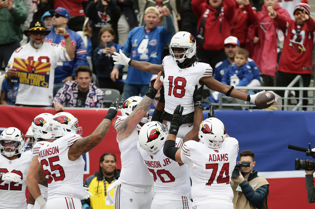 Arizona Cardinals wide receiver Marvin Harrison Jr. (18) celebrates his touchdown catch against the New York Giants with Cardinals guard Isaiah Adams (74), offensive tackle Paris Johnson Jr. (70) and offensive tackle Elijah Wilkinson (65) during an NFL football game, in East Rutherford, N.J., Sunday, Oct. 4, 2026. (AP Photo/Adam Hunger)