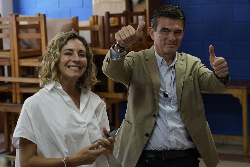 Presidential candidate Rodrigo Paz and his wife Maria Elena Urquidi pose as they accompany their daughter Catalina to vote during general elections in La Paz, Bolivia, Sunday, Aug. 17, 2025. (AP Photo/Freddy Barragan)