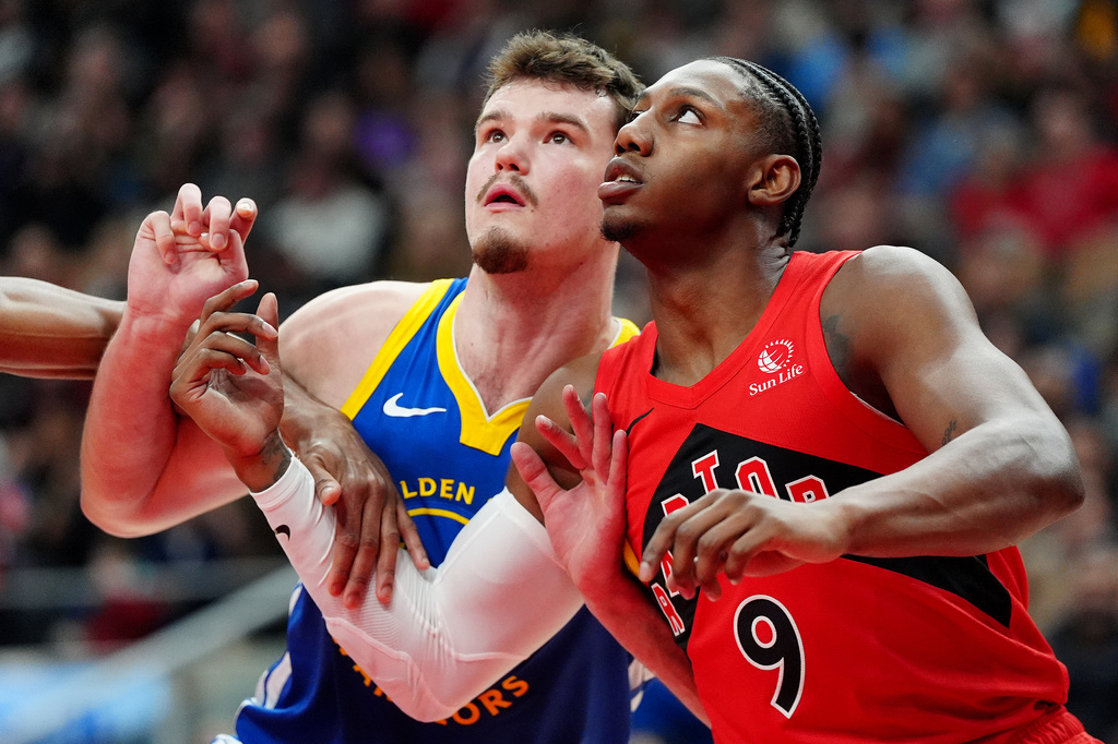 Golden State Warriors center Quinten Post, left, and Toronto Raptors forward RJ Barrett (9) watch for a rebound during first-half NBA basketball game action in Toronto, Sunday, Dec. 28, 2025. (Frank Gunn/The Canadian Press via AP)