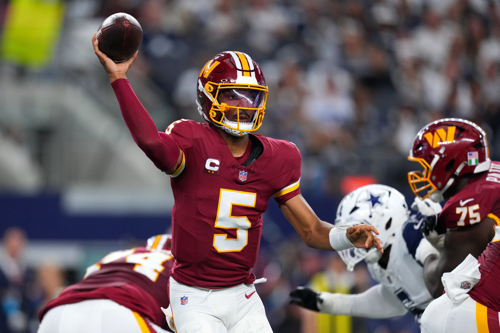 Washington Commanders quarterback Jayden Daniels (5) passes against the Dallas Cowboys in the first half during an NFL football game in Arlington, Texas, Sunday, Sept. 20, 2026. (AP Photo/Julio Cortez)