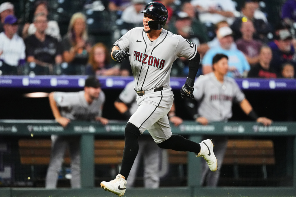 Arizona Diamondbacks' Ildemaro Vargas scores on a double hit by Gabriel Moreno off Colorado Rockies starting pitcher Kyle Freeland in the first inning of a baseball game Tuesday, Sept. 22, 2026, in Denver. (AP Photo/David Zalubowski)
