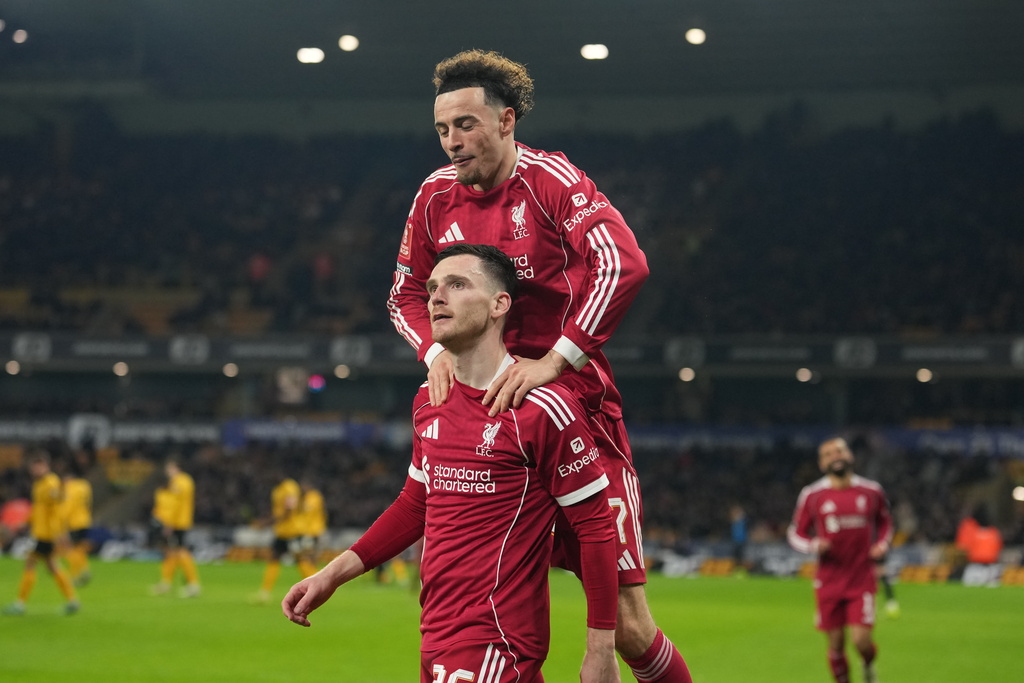 Liverpool's Andrew Robertson celebrates with teammate Liverpool's Curtis Jones after scoring during the English FA Cup soccer match between Wolves and Liverpool in Wolverhampton, England, Friday, March 6, 2026.(AP Photo/Dave Shopland)