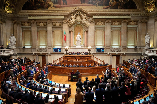 FILE - Members of opposition parties stand to vote against a government confidence motion at the Portuguese parliament in Lisbon, Tuesday, March 11, 2025. (AP Photo/Armando Franca, file) FILE - Members of opposition parties stand to vote against a government confidence motion at the Portuguese parliament in Lisbon, Tuesday, March 11, 2025. (AP Photo/Armando Franca, file)