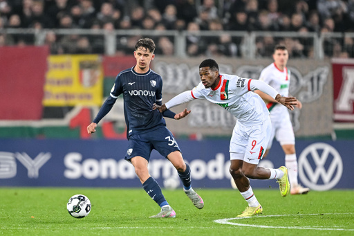 Augsburg's Samuel Essende, right, and Bochum's Cajetan Lenz, left, challenge for the ball during a German soccer cup second round match between FC Augsburg and VfL Bochum in Augsburg, Germany, Tuesday, Oct. 28, 2025. (Harry Langer/dpa via AP) Augsburg's Samuel Essende, right, and Bochum's Cajetan Lenz, left, challenge for the ball during a German soccer cup second round match between FC Augsburg and VfL Bochum in Augsburg, Germany, Tuesday, Oct. 28, 2025. (Harry Langer/dpa via AP)