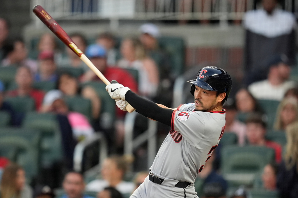 Cleveland Guardians' Steven Kwan (38) hits a single in the third inning of a baseball game against the Atlanta Braves, Friday, April 10, 2026, in Atlanta. (AP Photo/Mike Stewart)