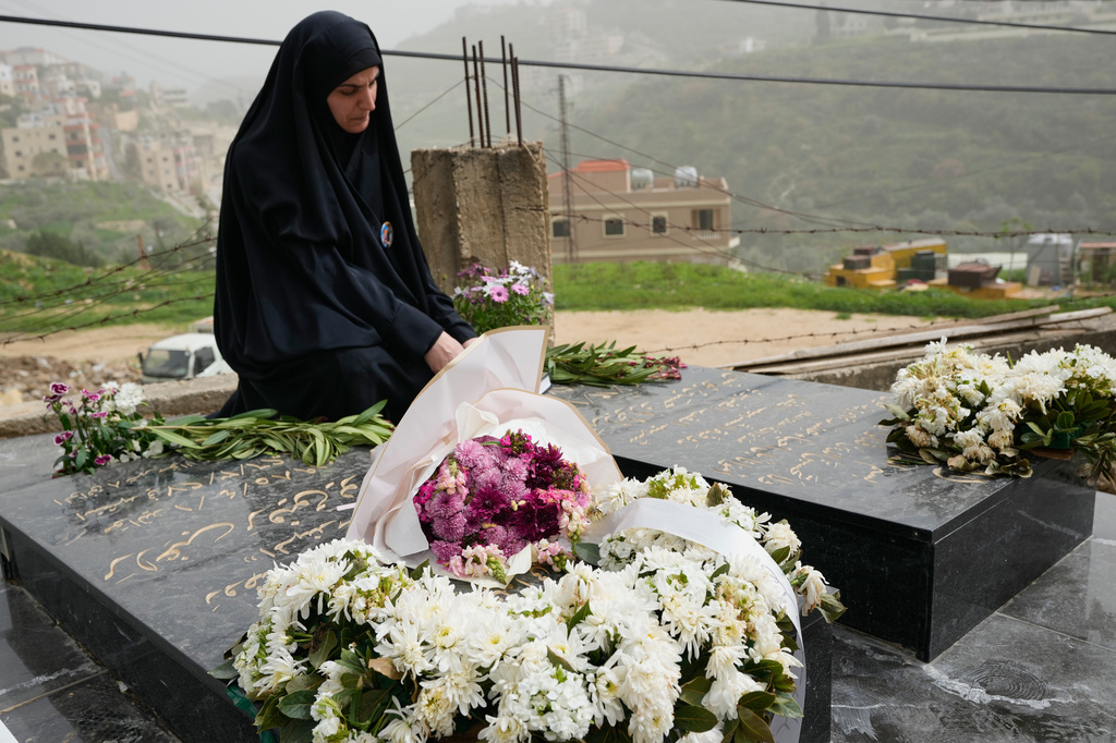 Malak Meslmani, the mother of Jawad Younes, 11, who was killed on March 27, 2026 in an Israeli airstrike, visits her son's grave in Saksakieh village, south Lebanon, Friday, April 3, 2026. (AP Photo/Hussein Malla)